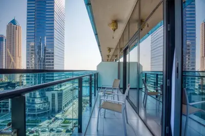a balcony with chairs and a view of the city at 1-Bedroom in Merano Tower, Business Bay with City Views in Dubai
