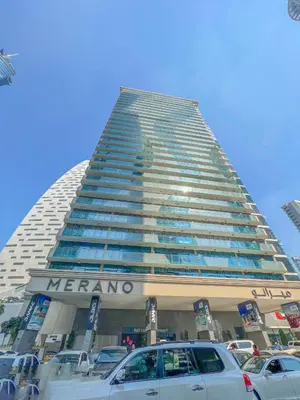 a large building with cars parked in front of it at 1-Bedroom in Merano Tower, Business Bay with City Views in Dubai