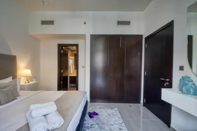 a bedroom with a bed with towels on it at 1-Bedroom in Merano Tower, Business Bay with City Views in Dubai