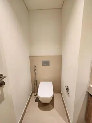 a bathroom with a white toilet in a stall at Your Dubai Home in Dubai