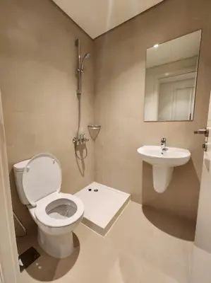 a bathroom with a toilet and a sink at Your Dubai Home in Dubai