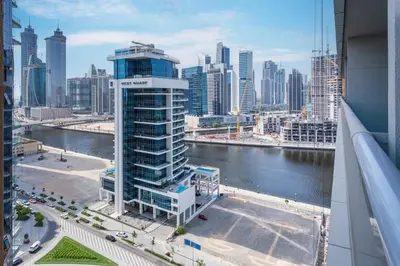 a view of a city skyline with a tall building at Canal View, 1BR, Terrace I Gym, Pool, Parking in Dubai