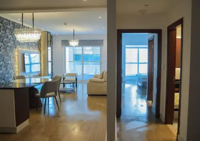 a living room and a dining room with a dining table at Stunning SeaView Elite Residence Dubai Marina in Dubai