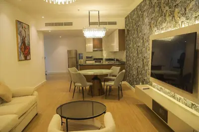 a living room with a couch and a table and chairs at Stunning SeaView Elite Residence Dubai Marina in Dubai