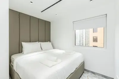 a bedroom with a large white bed with a window at Luxury 4 Bed apartment in Murjan, JBR in Dubai