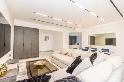 a living room with a white couch and a table at Luxury 4 Bed apartment in Murjan, JBR in Dubai
