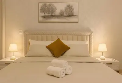 a bedroom with a bed with towels on it at Elegant 1BR Apartment in Dubai LuxuryStay in Dubai