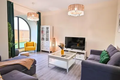 a living room with a couch and a tv at 7 Beds - JBR Beach 3 min walk in Dubai