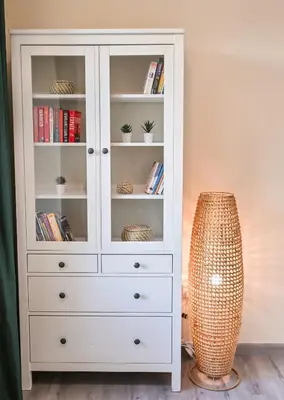 a white bookcase with a lamp in a room at 7 Beds - JBR Beach 3 min walk in Dubai