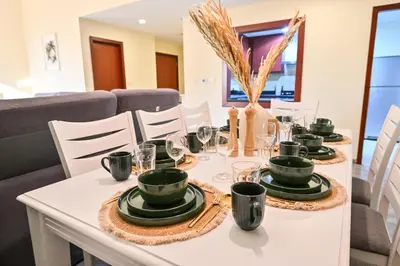 a white table with plates and glasses on it at 7 Beds - JBR Beach 3 min walk in Dubai