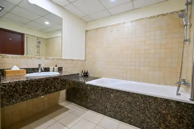 a bathroom with two sinks and a bath tub at 7 Beds - JBR Beach 3 min walk in Dubai