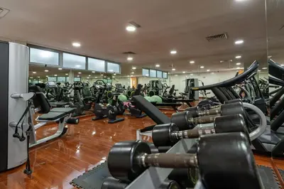 a gym with a lot of treadmills and machines at Lovey Unique Property- Garden and Barbeque Area in Dubai