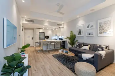 a living room with a couch and a kitchen at Lovey Unique Property- Garden and Barbeque Area in Dubai