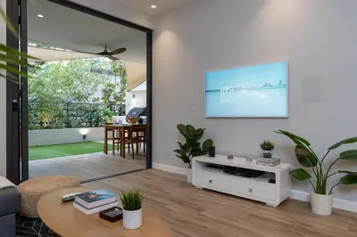 a living room with a tv and a table at Lovey Unique Property- Garden and Barbeque Area in Dubai