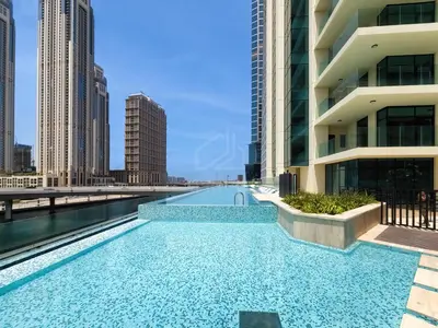 a swimming pool in the middle of a building with tall buildings at Wonderful New Studio in Missoni Business Bay in Dubai