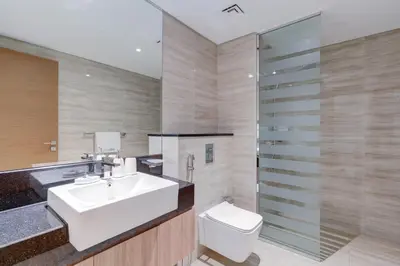 a bathroom with a sink and a toilet and a shower at Luxury 1 bedroom Apartment in Urban Oasis by Missoni in Dubai