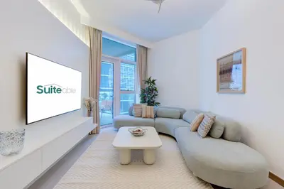 a living room with a couch and a table at Luxury 1 bedroom Apartment in Urban Oasis by Missoni in Dubai