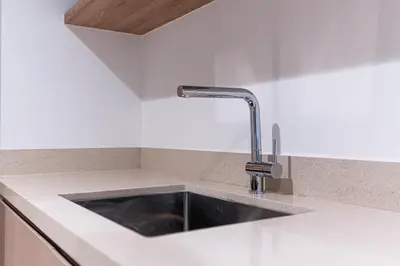 a kitchen with a sink in a white counter top at Luxury 1 bedroom Apartment in Urban Oasis by Missoni in Dubai