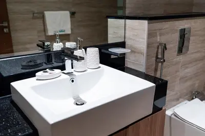 a bathroom with a white sink and a mirror at Luxury 1 bedroom Apartment in Urban Oasis by Missoni in Dubai