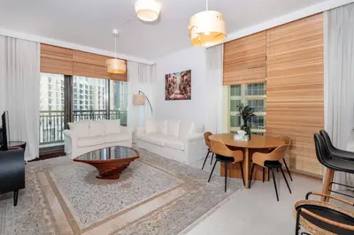a living room with a white couch and a table at 3 BR Dubai Creek Harbour in Dubai