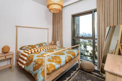a bedroom with a bed and a large window at 3 BR Dubai Creek Harbour in Dubai