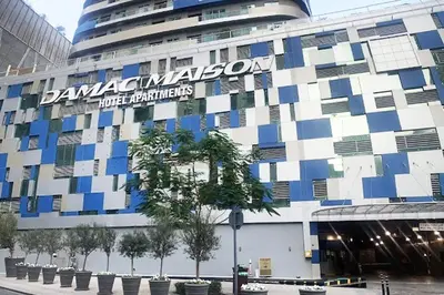 a building with a sign on the side of it at Vserve - 1 BR Iconic Burj Khalifa full view in Dubai