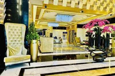 a lobby of a hotel with chairs and flowers at Vserve - 1 BR Iconic Burj Khalifa full view in Dubai
