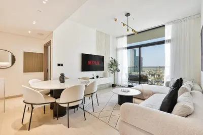 a living room with a couch and a table at Elegant - 3BR - near Palm Jumeirah - Pool and Gym in Dubai