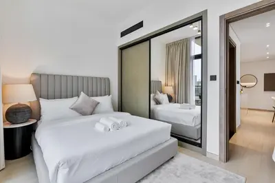 a bedroom with two beds and a mirror at Elegant - 3BR - near Palm Jumeirah - Pool and Gym in Dubai