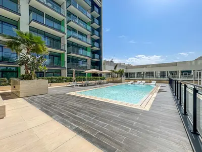 a swimming pool in the middle of a building at Elegant - 3BR - near Palm Jumeirah - Pool and Gym in Dubai