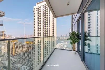 an apartment balcony with a view of a city at Manzil - 2BR Apartment in Palm Jumeirah with Marina View in Dubai