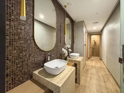 a bathroom with a sink and a large mirror at Modern Studio with Pool, Gym and BBQ area in Dubai
