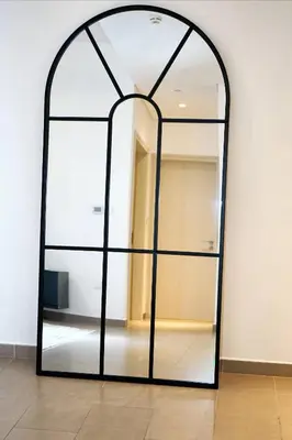 an arched mirror against a wall in a room at First class 1BR Hall in Park Heights in Dubai