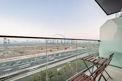 a balcony with a bench and a highway at Elegant Studio in Bloom Towers B, JVC by Deluxe Holiday Homes in Dubai