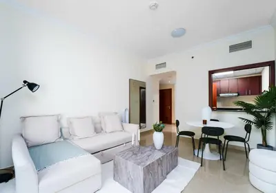 a living room with a white couch and a table at Perfect Stay - 1Bedroom with full Marina View in Dubai