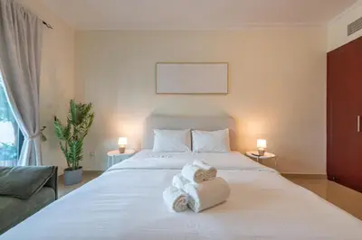 a bedroom with a bed with towels on it at Perfect Stay - 1Bedroom with full Marina View in Dubai