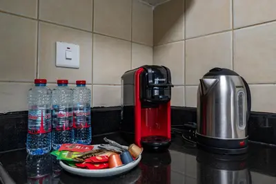 a counter with a coffee maker and bottles of water at Perfect Stay - 1Bedroom with full Marina View in Dubai