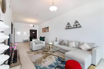 a living room with a couch and a table at Free Netflix, Sea View, Private Beach & Pool in Dubai