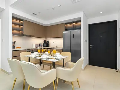 a kitchen and dining room with a table and chairs at Luxury Downtown Dubai Apartment - 5 Mins Walk to Burj, Opera, Dubai Mall, Sleep 1-10 in Dubai
