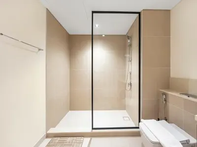 a bathroom with a shower and a toilet at Luxury Downtown Dubai Apartment - 5 Mins Walk to Burj, Opera, Dubai Mall, Sleep 1-10 in Dubai