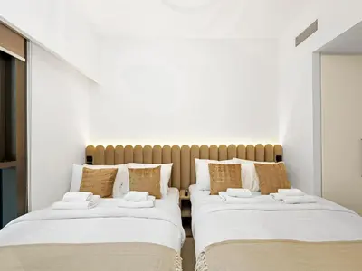 two beds sitting next to each other in a room at Luxury Downtown Dubai Apartment - 5 Mins Walk to Burj, Opera, Dubai Mall, Sleep 1-10 in Dubai