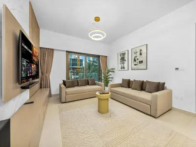 a living room with two couches and a flat screen tv at Luxury Downtown Dubai Apartment - 5 Mins Walk to Burj, Opera, Dubai Mall, Sleep 1-10 in Dubai