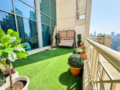 a small balcony with grass and plants on a building at Vserve - 1 BR Spacious Majestic Burj Khalifa view in Dubai