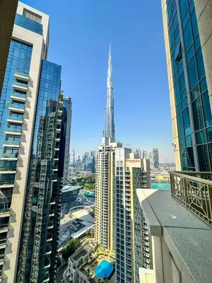 a view of a city with tall buildings at Vserve - 1 BR Spacious Majestic Burj Khalifa view in Dubai