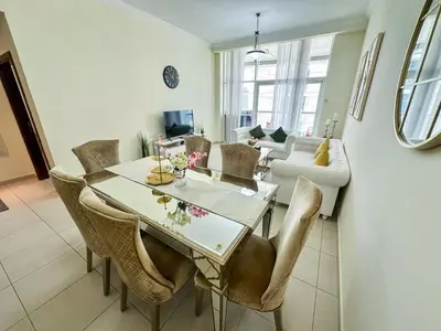 a dining room with a table and chairs at Vserve - 1 BR Stunning Canal and Burj Khalifa View in Dubai