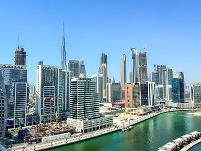 a view of a city with a river and buildings at Vserve - 1 BR Stunning Canal and Burj Khalifa View in Dubai
