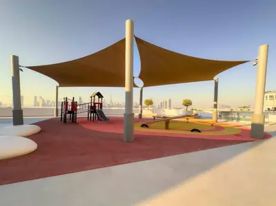 a playground with a canopy on a roof at Premium 1BR Haven with Burj Khalifa, City Skyline Views, Pool, Gym & Balcony in Dubai