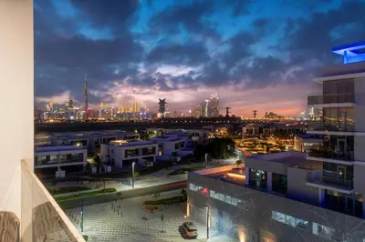 a view of a city skyline at night at Premium 1BR Haven with Burj Khalifa, City Skyline Views, Pool, Gym & Balcony in Dubai