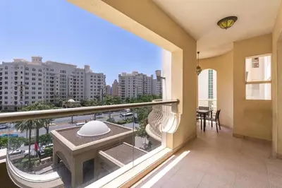 a balcony with a table and a view of a city at FIRST CLASS 2BR Cozy Beachfront Escape in Dubai