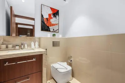 a bathroom with a toilet and a sink at Skyline Views 2BR Near Burj Khalifa & Dubai Mall with Pool Access in Dubai